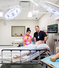 Student and instructor in Coleman simulated medical lab.