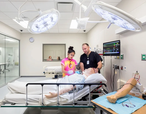 Student and instructor in Coleman simulated medical lab.
