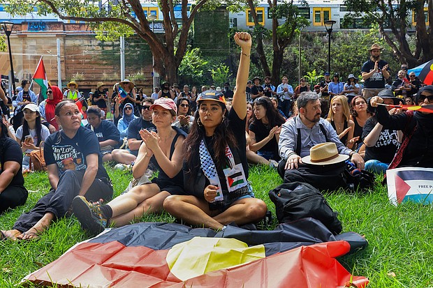 Protesters carry the Aboriginal flag as Indigenous leaders speak about the injustices inflicted through colonization.
Mandatory Credit:	Jenny Evans/Getty Images