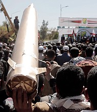 Yemenis lift a mock missile at a protest against the US-led airstrikes on Yemen.
Mandatory Credit:	Mohammed Hamoud/Getty Images