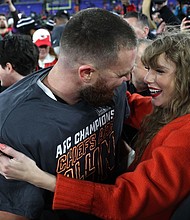 (From left) Travis Kelce and Taylor Swift celebrating on the field in Baltimore on Sunday as the Chiefs advance to the Super Bowl.
Mandatory Credit:	Patrick Smith/Getty Images
