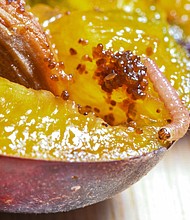 A caterpillar of a plum moth (Grapholita funebrana) crawls over a cut plum.
Mandatory Credit:	Patrick Pleul/picture alliance/Getty Images