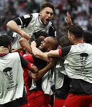 Jordan's players celebrate their win over Iraq.
Mandatory Credit:	Karim Jaafar/AFP/Getty Images