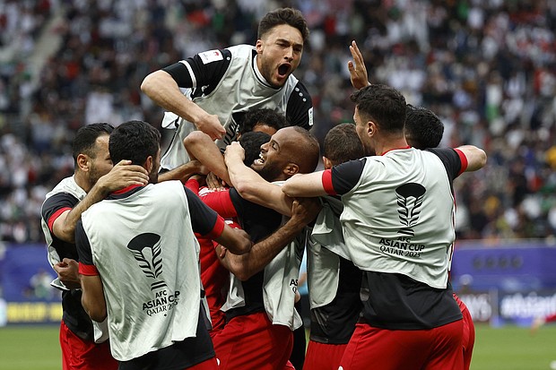 Jordan's players celebrate their win over Iraq.
Mandatory Credit:	Karim Jaafar/AFP/Getty Images
