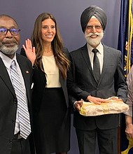 Amrith Kaur Aakre (second from left) poses during her swearing-in ceremony as the director of the EEOC’s Chicago District on Jan. 29, with Thomas Colclough, director of field management programs, and her parents Rajinder and Navinder Mago. Aakre took her oath on the Sikh holy book, the Guru Granth Sahib.