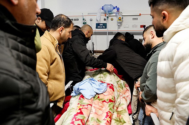 Mourners grieve next to the body of a Palestinian man killed in the raid.
Mandatory Credit:	Raneen Sawafta/Reuters