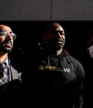 The three plaintiffs who filed a lawsuit against the Japanese government alleging racial profiling stand outside the Tokyo District Court on January 29, 2024.
Mandatory Credit:	Philip Fong/AFP/Getty Images