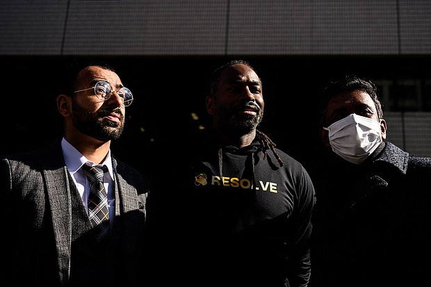 The three plaintiffs who filed a lawsuit against the Japanese government alleging racial profiling stand outside the Tokyo District Court on January 29, 2024.
Mandatory Credit:	Philip Fong/AFP/Getty Images