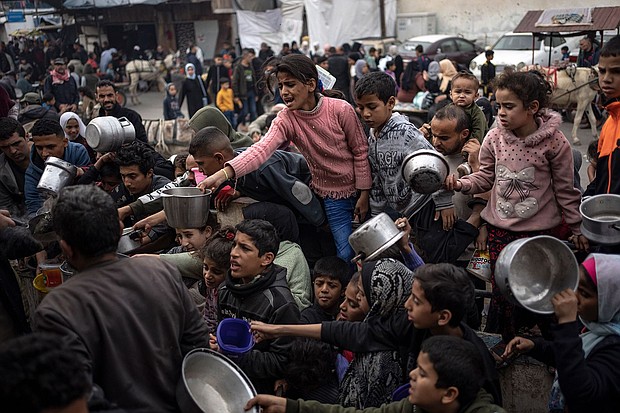 Palestinians line up for a free meal in Rafah, Gaza Strip, Thursday, December 21, 2023.
Mandatory Credit:	Fatima Shbair/AP
