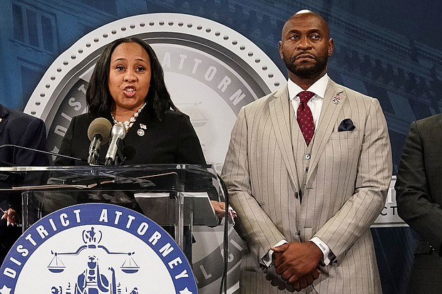 Fulton County District Attorney Fani Willis speaks at a press conference next to prosecutor Nathan Wade after a Grand Jury brought back indictments against former president Donald Trump and his allies in their attempt to overturn the state's 2020 election results, in Atlanta, Georgia, on August 14, 2023.
Mandatory Credit:	Elijah Nouvelage/Reuters/File