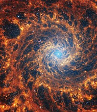 This Webb image shows a densely populated spiral galaxy anchored by a central region that has a light blue haze, known NGC 628. It's 32 million light-years away in the constellation Pisces.
Mandatory Credit:	NASA, ESA, CSA, STScI, J. Lee (STScI), T. Williams (Oxford), PHANGS Team