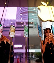Apple saw an upswing after four consecutive quarters of sales declines, and seen here are people at an Apple store in Shanghai, China, in September 2023.
Mandatory Credit:	Aly Song/Reuters