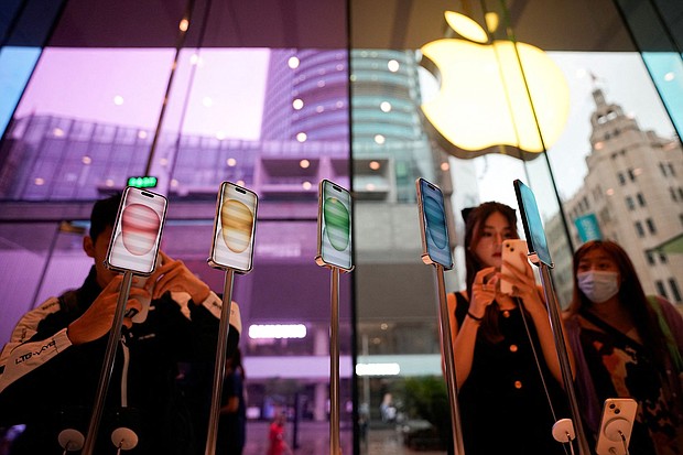 Apple saw an upswing after four consecutive quarters of sales declines, and seen here are people at an Apple store in Shanghai, China, in September 2023.
Mandatory Credit:	Aly Song/Reuters