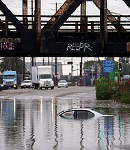 Cars are submerged on a flooded street in Long Beach, California.
Mandatory Credit:	Eric Thayer/AP
