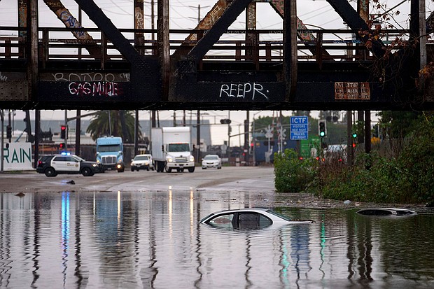 Cars are submerged on a flooded street in Long Beach, California.
Mandatory Credit:	Eric Thayer/AP