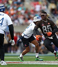 David Njoku runs with the ball while Bobby Wagner attempts to grab his flag.
Mandatory Credit:	Megan Briggs/Getty Images