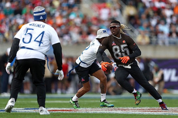 David Njoku runs with the ball while Bobby Wagner attempts to grab his flag.
Mandatory Credit:	Megan Briggs/Getty Images