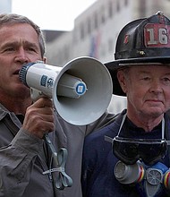 President George W. Bush, left, stands next to retired New York Fire Department firefighter Bob Beckwith on September 14, 2001, three days after the 9/11 terror attacks.
Mandatory Credit:	Paul Richards/AFP via Getty Images