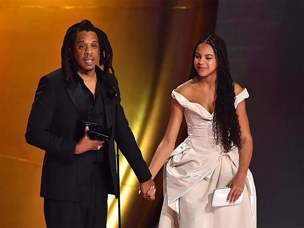 JayZ and Blue Ivy Carter holding hands at the Grammys./ Getty Images @gettyimages, Valerie Macon @valeriemacon