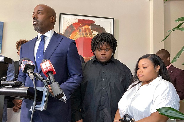 Attorney Cory Lynch, left, joined by Treveon Isaiah Taylor, Sr., Jessica Ross, speaks during a news conference in August 2023 in Atlanta.
Mandatory Credit:	Sudhin Thanawala/AP/File