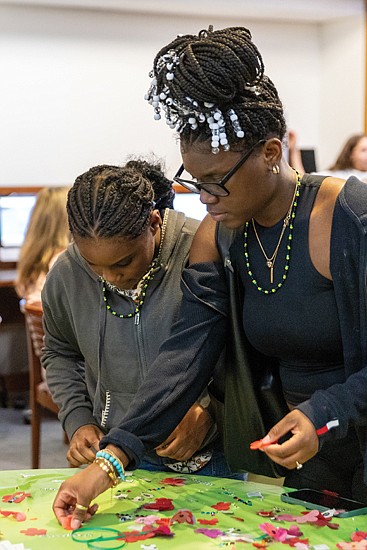 Alayla Kerr, 11 (left) and her sister, Makayla Robinson, 18, make part of a collaborative peony flower curtain at the Virginia Museum of Fine Arts during ChinaFest:
Year of the Wood Dragon on Saturday, Feb. 3. The peony, known as the “king of flowers” in China, symbolizes wealth, royalty and beauty.