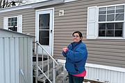 Amy Case stands in her mobile home park, Jan. 23, in Auburn, Mass., where residents complain they are facing double-digit rent increases that they cannot afford. Their concerns are echoed nationally where a report from Harvard University found 22.4 million households are rent burdened.