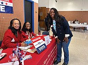 Priscilla Goldsborough and Gwen Davis distribute voter registration information during the program. Byesheba Entzminger-Bullock, director of Changing Faces, a mental health provider, was a vendor during the event.