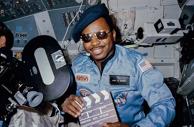Astronaut Ronald E. McNair doubles as "director" for a movie being "produced" aboard the Earth-orbiting Space Shuttle Challenger in February 1984.
Mandatory Credit:	NASA