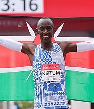 Kelvin Kiptum celebrates after winning the 2023 Chicago Marathon professional men's division and setting a world record marathon time of 2:00.35 at Grant Park on October 8, 2023 in Chicago, Illinois.
Mandatory Credit:	Michael Reaves/Getty Images