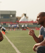 Umenyiora greets the boy, played by Eldad Osime, at the NFL camp during the commercial.
Mandatory Credit:	NFL