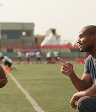 Umenyiora greets the boy, played by Eldad Osime, at the NFL camp during the commercial.
Mandatory Credit:	NFL