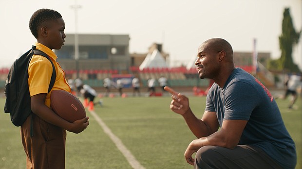 Umenyiora greets the boy, played by Eldad Osime, at the NFL camp during the commercial.
Mandatory Credit:	NFL