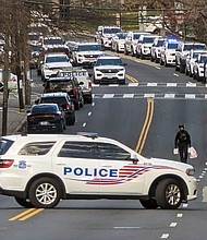 Police are shown near the scene where three police officers were shot Wednesday in Washington, DC.
Mandatory Credit:	Nathan Ellgren/AP