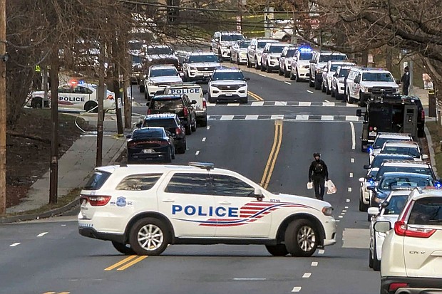 Police are shown near the scene where three police officers were shot Wednesday in Washington, DC.
Mandatory Credit:	Nathan Ellgren/AP