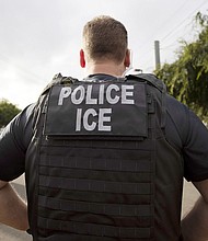 A U.S. Immigration and Customs Enforcement (ICE) officer looks on during an operation in Escondido, Calif., July 8, 2019.
Mandatory Credit:	Gregory Bull/AP/FILE