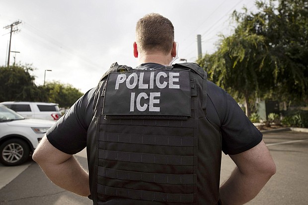 A U.S. Immigration and Customs Enforcement (ICE) officer looks on during an operation in Escondido, Calif., July 8, 2019.
Mandatory Credit:	Gregory Bull/AP/FILE