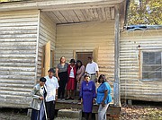 Hancy Hatchett, the Rev. George Magazine, Nancy Phaup, Prince Wallace, Sylvia Bradby Christian, James Marrow, Melinda Brown and Gwen Christian stand at the former Mt. Zion School, which many of their ancestors attended.