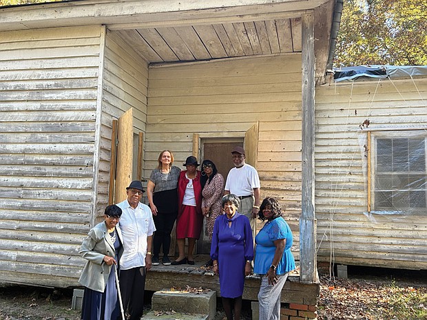 Hancy Hatchett, the Rev. George Magazine, Nancy Phaup, Prince Wallace, Sylvia Bradby Christian, James Marrow, Melinda Brown and Gwen Christian stand at the former Mt. Zion School, which many of their ancestors attended.