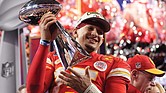 Kansas City Chiefs quarterback Patrick Mahomes celebrates with the trophy Sunday after the team’s overtime win during Super Bowl LVIII against the San Francisco 49ers in Las Vegas. Behind him is Kansas City Chiefs Coach Andy Reid. The Chiefs won 25-22.