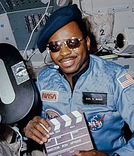 Astronaut Ronald E. McNair doubles as "director" for a movie being "produced" aboard the Earth-orbiting Space Shuttle Challenger in February 1984.
Mandatory Credit:	NASA