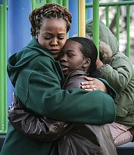 Derry Oliver, 17, right, hugs her mother, also Derry Oliver, during a Feb. 9 visit to a playground in New York. During the COVID-19 pandemic, the younger Oliver embraced therapy as she struggled with the isolation of remote learning, even as her mother pushed back.