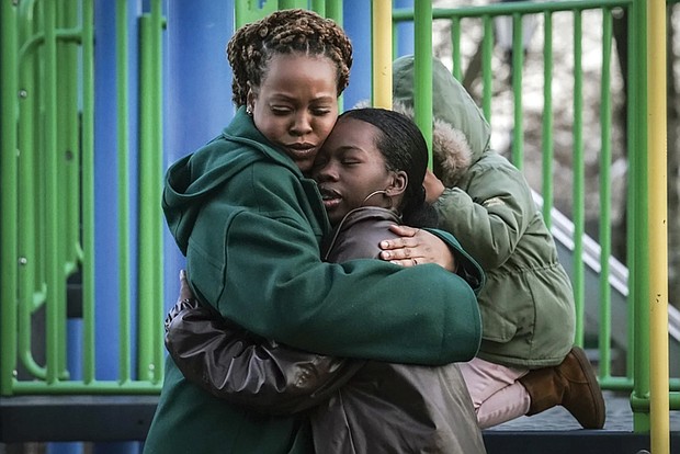 Derry Oliver, 17, right, hugs her mother, also Derry Oliver, during a Feb. 9 visit to a playground in New York. During the COVID-19 pandemic, the younger Oliver embraced therapy as she struggled with the isolation of remote learning, even as her mother pushed back.