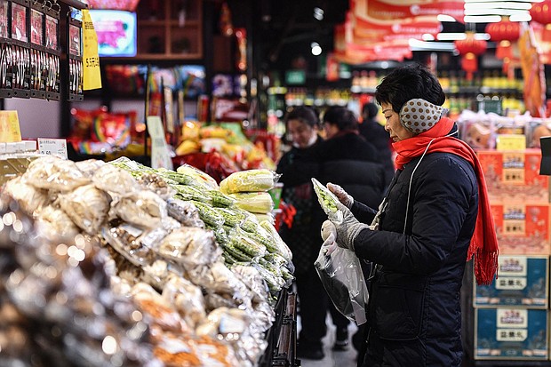 Customers shop for vegetables and fruit at a supermarket in Fuyang, China, on February 8, 2024.
Mandatory Credit:	STR/AFP/Getty Images