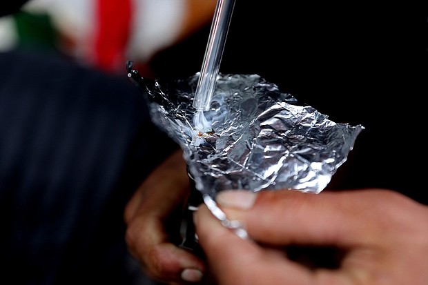 The percentage of overdose deaths linked to smoking drugs rose sharply in recent years. Pictured is an individual smoking fentanyl.
Mandatory Credit:	Gary Coronado/Los Angeles Times/Getty Images