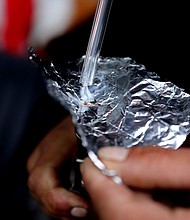 The percentage of overdose deaths linked to smoking drugs rose sharply in recent years. Pictured is an individual smoking fentanyl.
Mandatory Credit:	Gary Coronado/Los Angeles Times/Getty Images