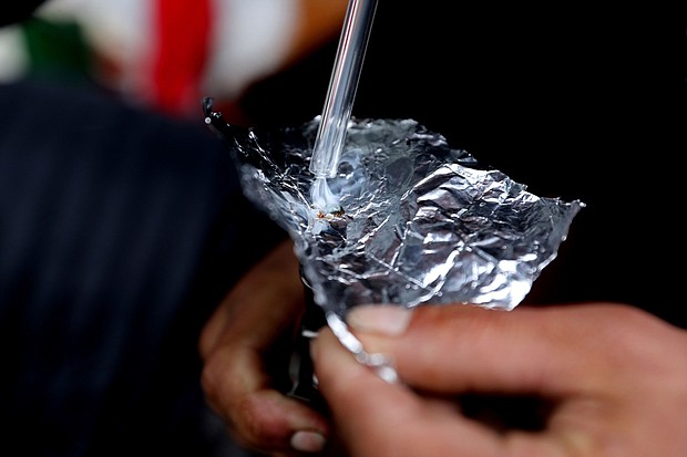 The percentage of overdose deaths linked to smoking drugs rose sharply in recent years. Pictured is an individual smoking fentanyl.
Mandatory Credit:	Gary Coronado/Los Angeles Times/Getty Images