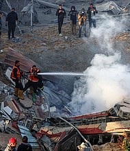 Members of the Palestinian civil defense extinguish a fire in a building in the east of Rafah, the southern Gaza Strip, Monday, February 19.
Mandatory Credit:	Said Khatib/AFP/Getty Images