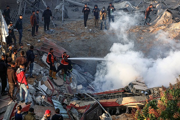 Members of the Palestinian civil defense extinguish a fire in a building in the east of Rafah, the southern Gaza Strip, Monday, February 19.
Mandatory Credit:	Said Khatib/AFP/Getty Images