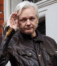 Julian Assange gestures while speaking to the media from the balcony of the Ecuadorian Embassy on May 19, 2017 in London.
Mandatory Credit:	Jack Taylor/Getty Images