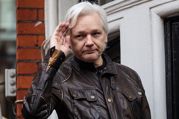 Julian Assange gestures while speaking to the media from the balcony of the Ecuadorian Embassy on May 19, 2017 in London.
Mandatory Credit:	Jack Taylor/Getty Images